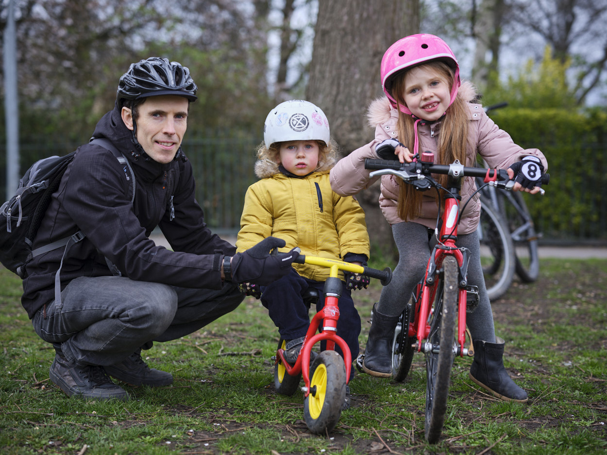 Family of three posing with cycles